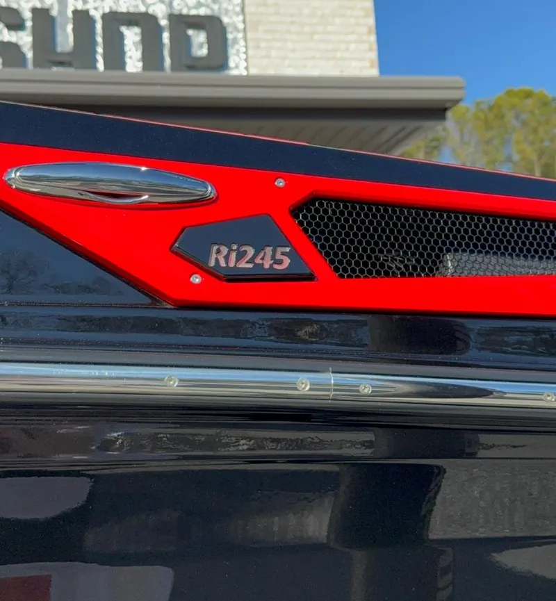 Slide: The Image of 2025 Centurion Ri245 boat detail with red and black accents, outdoors. - 7