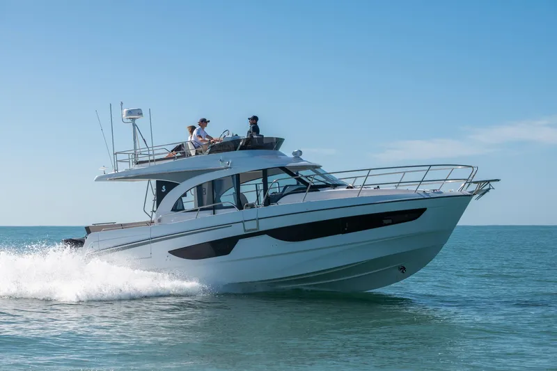 Slide: The Image of 2025 Beneteau Antares 11 Fly cruising on open water under clear skies. - 20