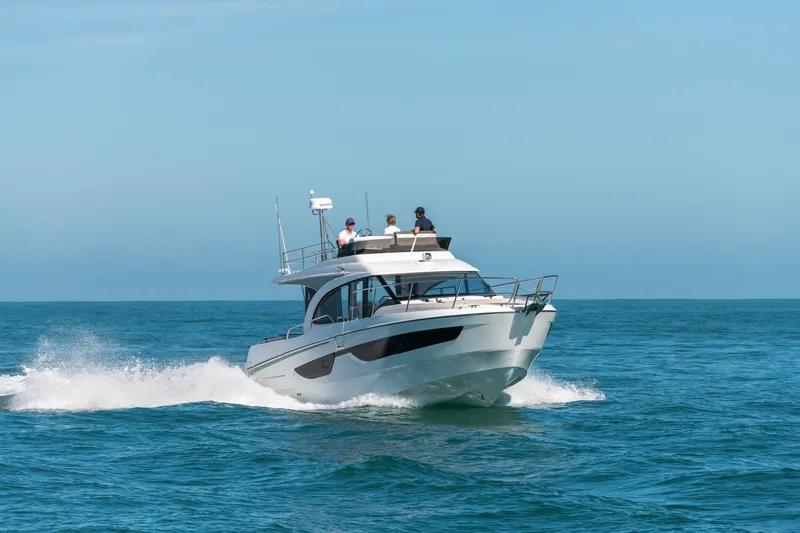 Slide: The Image of 2025 Beneteau Antares 11 Fly cruising on open sea under clear blue sky. - 21