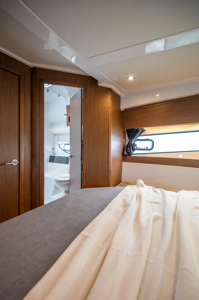 Slide: The Image of 2025 Beneteau Antares 11 Fly cabin interior with modern wood finish and natural lighting. - 32