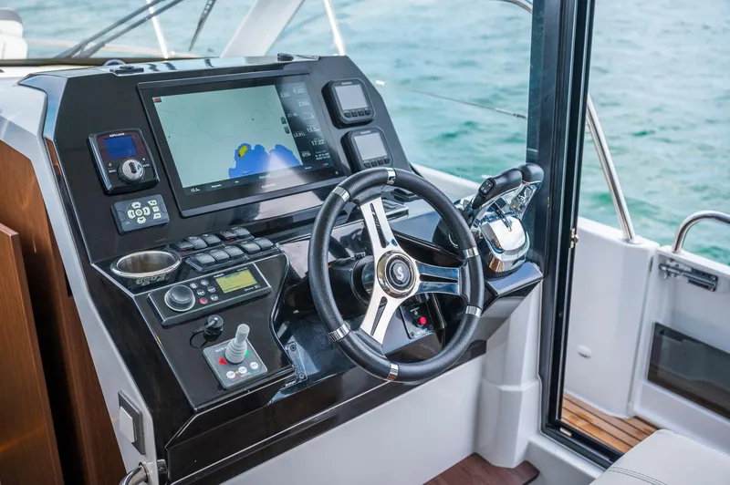 Slide: The Image of Helm of 2025 Beneteau Antares 11 Fly, featuring advanced navigation controls and steering wheel. - 34