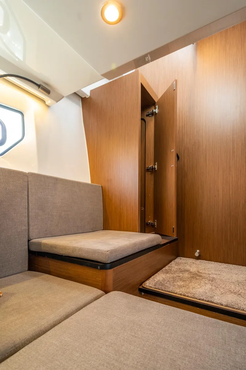 Slide: The Image of Interior of 2025 Beneteau Antares 11 Fly, featuring modern seating and wooden paneling. - 40