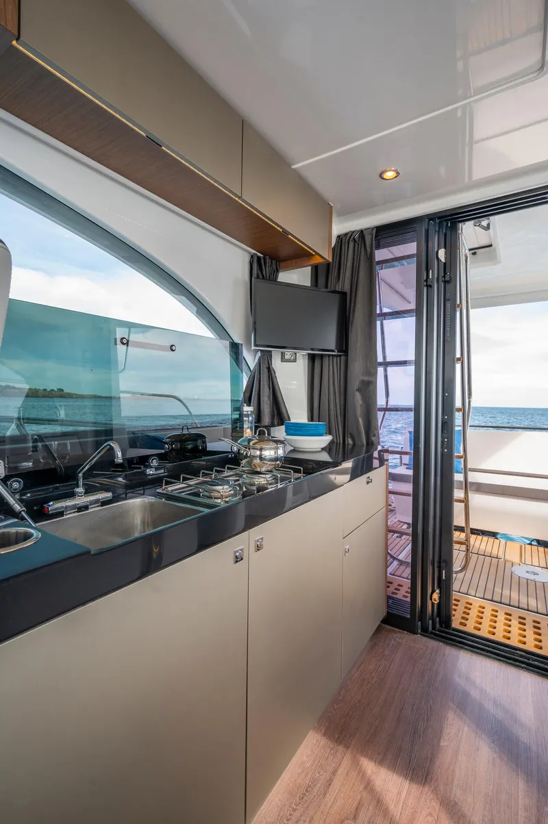 Slide: The Image of Modern kitchen interior on 2025 Beneteau Antares 11 Fly yacht with ocean view. - 46