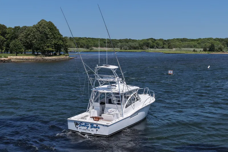 Slide: The Image of 2022 Albemarle 360 Express Fisherman boat on a scenic lake with lush green shoreline. - 13