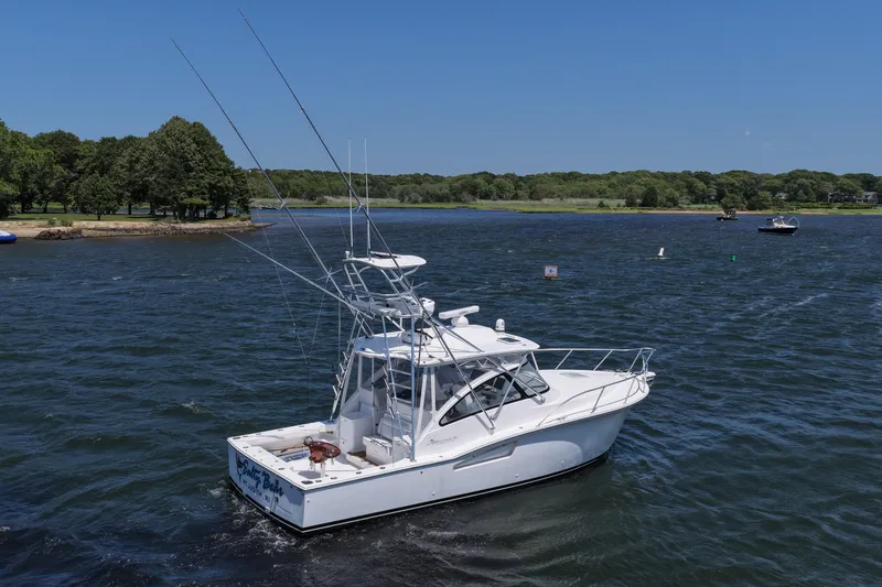 Slide: The Image of 2022 Albemarle 360 Express Fisherman boat cruising on a scenic lake. - 14