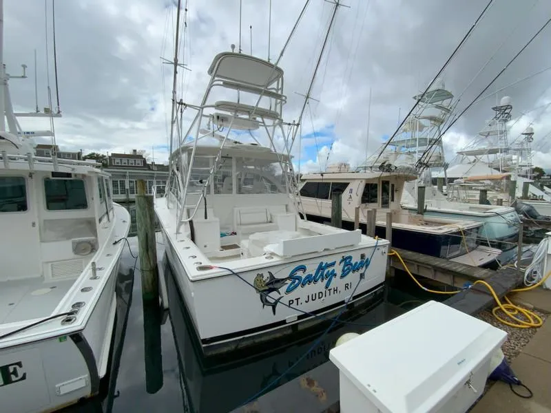 Slide: The Image of 2022 Albemarle 360 Express Fisherman docked at marina, featuring spacious deck and fishing equipment. - 23
