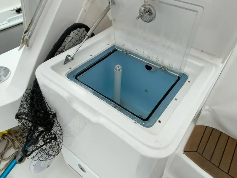 Slide: The Image of Livewell on 2022 Albemarle 360 Express Fisherman boat, featuring fishing net and storage. - 30