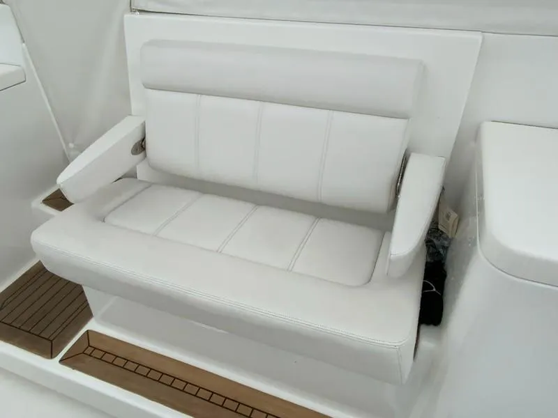 Slide: The Image of White seating on 2022 Albemarle 360 Express Fisherman boat, featuring cushioned armrests. - 31