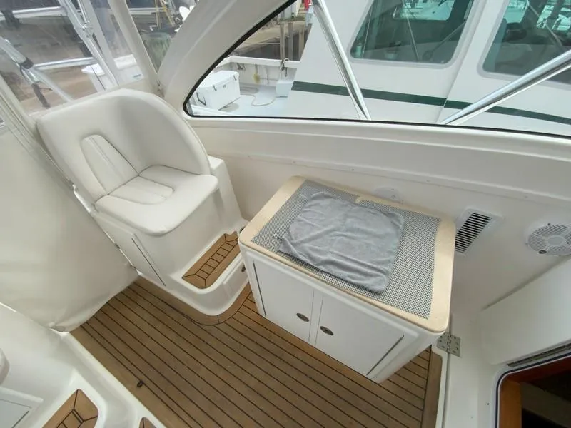Slide: The Image of 2022 Albemarle 360 Express Fisherman interior with seating and storage on teak flooring. - 43