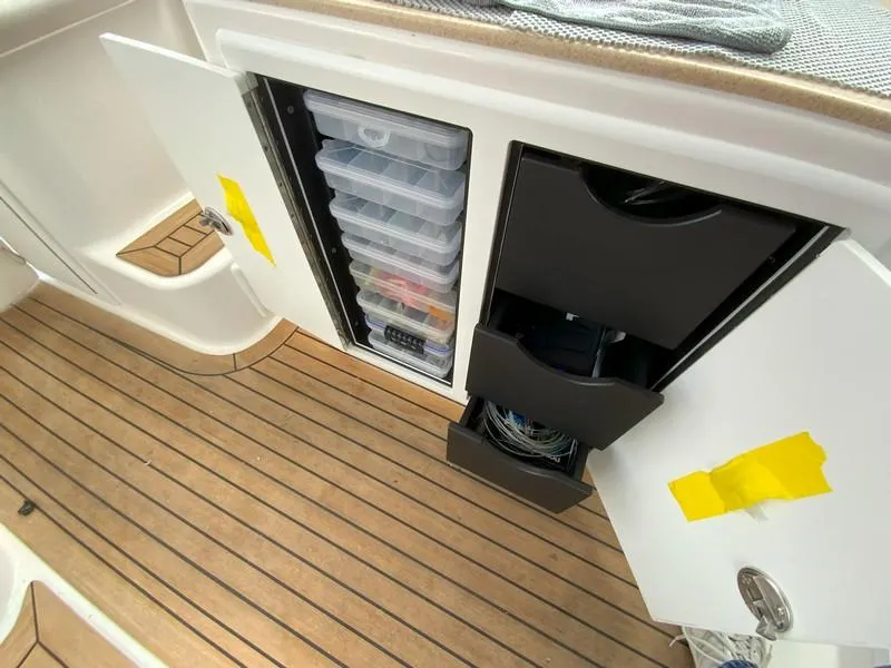 Slide: The Image of Storage compartments on 2022 Albemarle 360 Express Fisherman boat with organized tackle boxes. - 44