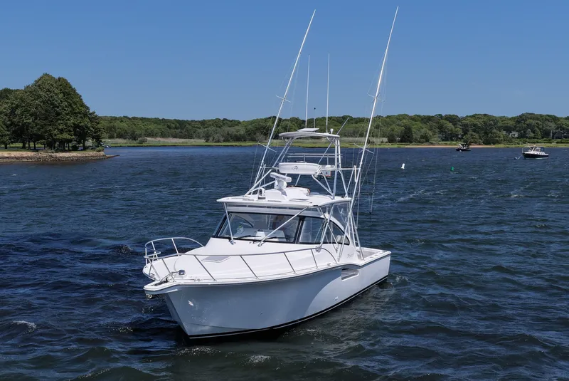 Slide: The Image of 2022 Albemarle 360 Express Fisherman boat on a scenic lake with trees in the background. - 6