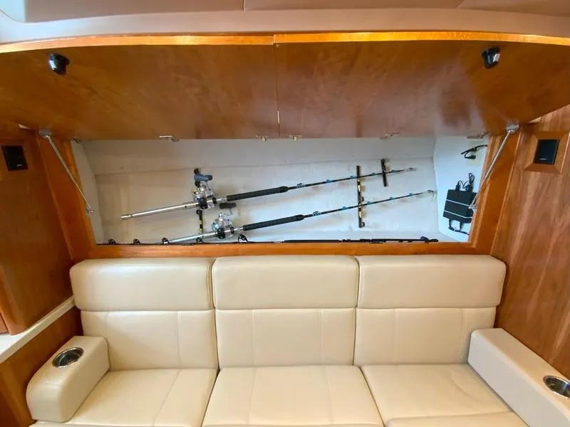 Slide: The Image of 2022 Albemarle 360 Express Fisherman interior with fishing rod storage above beige seating. - 62