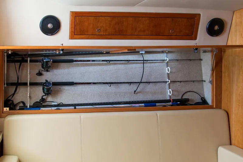 Slide: The Image of Storage compartment with fishing rods in a 2022 Albemarle 360 Express Fisherman boat. - 63