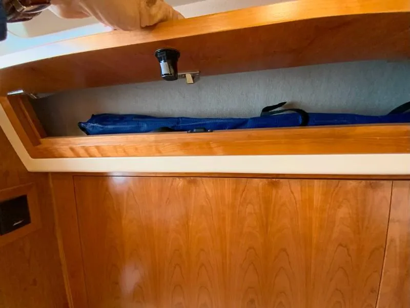 Slide: The Image of 2022 Albemarle 360 Express Fisherman interior storage compartment with wooden finish. - 64