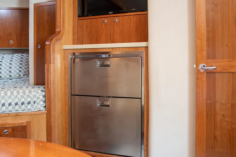 Slide: The Image of Interior of 2022 Albemarle 360 Express Fisherman with wood cabinetry and stainless steel appliances. - 66
