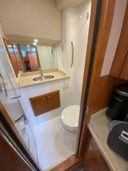 Slide: The Image of 2022 Albemarle 360 Express Fisherman bathroom with sink, toilet, and wooden cabinetry. - 68