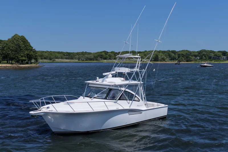 Slide: The Image of 2022 Albemarle 360 Express Fisherman boat on a scenic lake with trees in the background. - 7