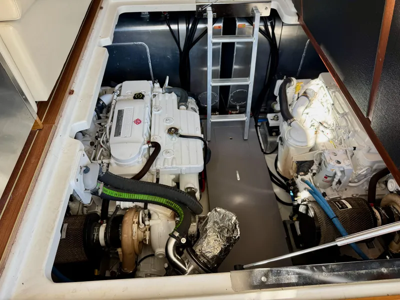 Slide: The Image of Engine room of 2020 Beneteau Swift Trawler 47 with dual engines and ladder access. - 11