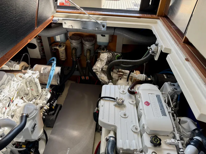 Slide: The Image of Engine room of 2020 Beneteau Swift Trawler 47, showcasing dual engines and mechanical components. - 19