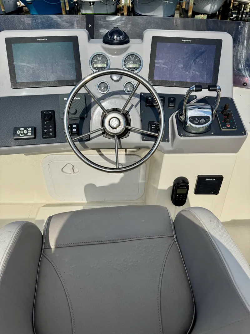 Slide: The Image of 2020 Beneteau Swift Trawler 47 helm with dual displays and steering wheel. - 29