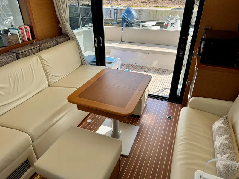 Slide: The Image of Interior of 2020 Beneteau Swift Trawler 47 with elegant seating and wooden table. - 3