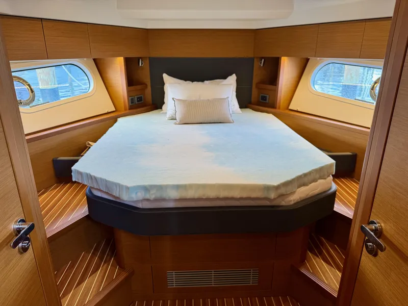 Slide: The Image of Luxurious bedroom interior of 2020 Beneteau Swift Trawler 47 with elegant wood finish. - 5