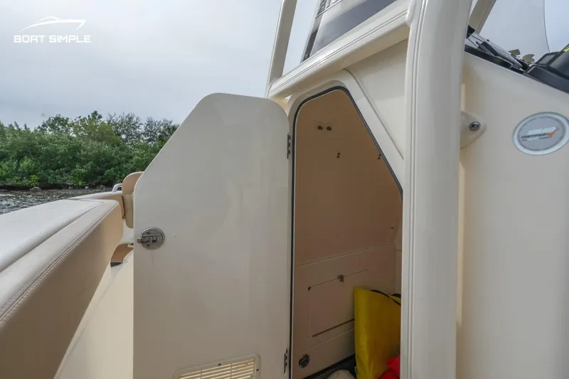 Slide: The Image of 2023 Scout 215 XSF boat interior storage compartment with open door. - 11