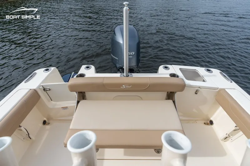 Slide: The Image of 2023 Scout 215 XSF boat interior with seating and outboard motor on water. - 6