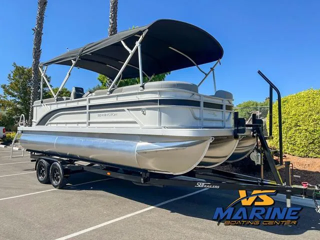 Slide: The Image of 2024 Bennington 22 SSR pontoon boat cruising on a lake with passengers enjoying the ride. - 2