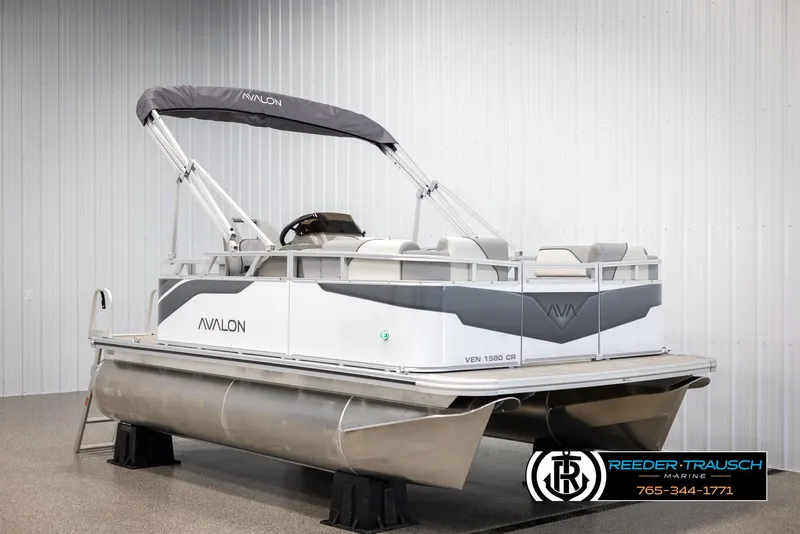 Slide: The Image of 2025 Avalon VEN CR pontoon boat in showroom, featuring sleek design and modern amenities. - 1