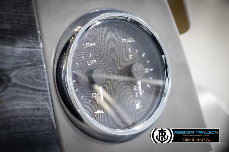 Slide: The Image of Close-up of Avalon VEN CR 2025 boat gauge showing trim and fuel levels. - 27