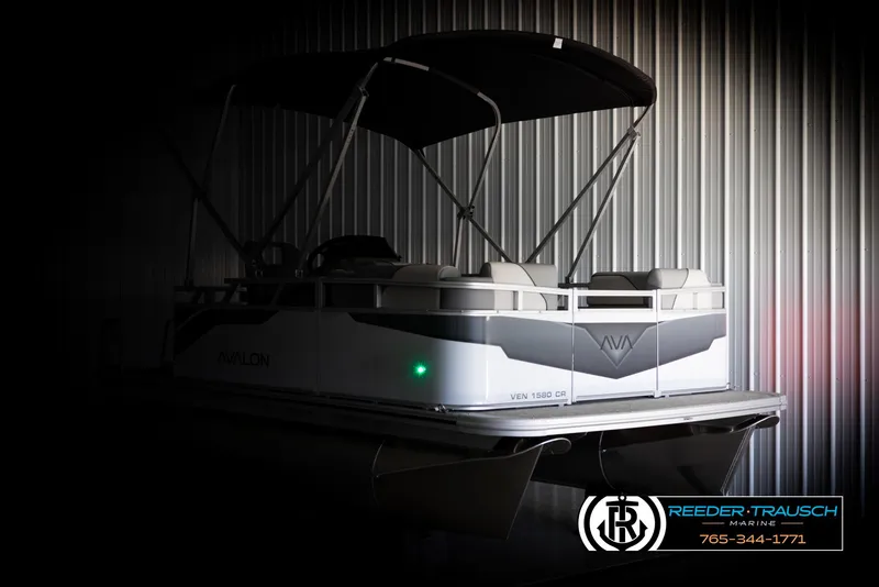 Slide: The Image of 2025 Avalon VEN CR pontoon boat in a dimly lit showroom. - 3
