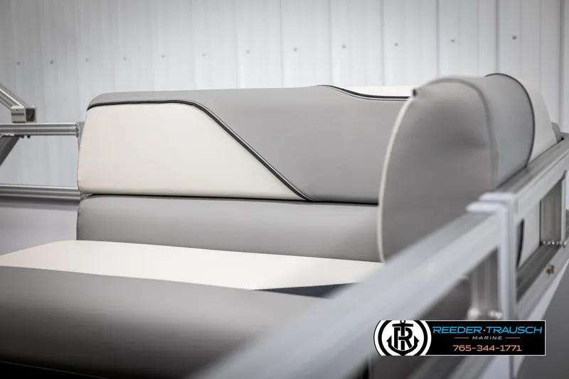 Slide: The Image of 2025 Avalon VEN CR boat interior with gray and white seating, Reeder-Trausch Marine logo. - 30