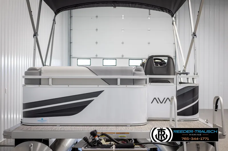 Slide: The Image of 2025 Avalon VEN CR pontoon boat in showroom, featuring sleek design and modern seating. - 6