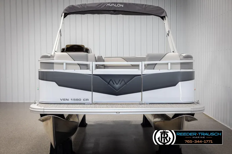 Slide: The Image of 2025 Avalon VEN CR pontoon boat in showroom, featuring sleek design and modern seating. - 7