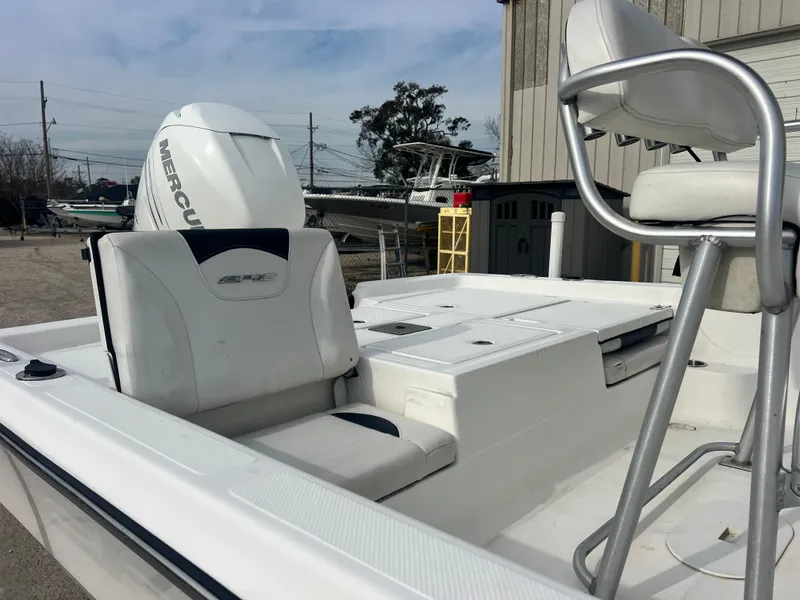 Slide: The Image of 2015 Epic 22 Sport Console boat with Mercury engine, white seating, and console. - 4