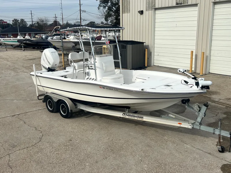 Slide: The Image of 2015 Epic 22 Sport Console boat on trailer, parked outside a warehouse. - 5