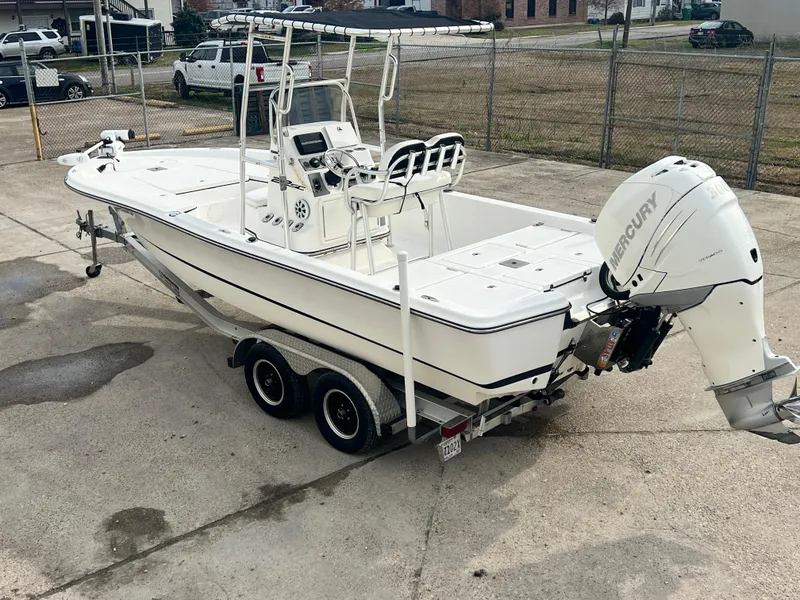 Slide: The Image of 2015 Epic 22 Sport Console boat on trailer with Mercury outboard motor. - 9