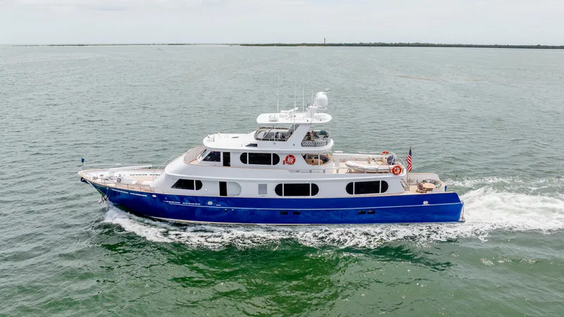 The Image of 1975 Stephens Brothers Expedition yacht cruising on open water, featuring a sleek blue and white design. - 1