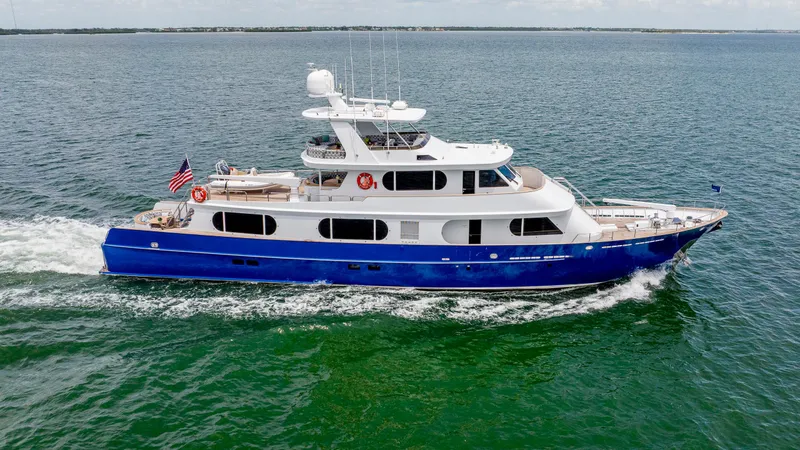 Slide: The Image of 1975 Stephens Brothers Expedition yacht cruising on open water, featuring a sleek blue and white design. - 3