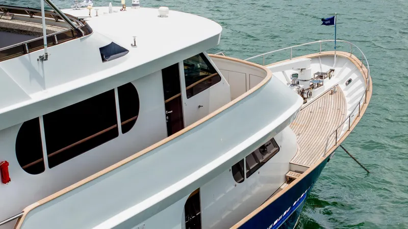 Slide: The Image of 1975 Stephens Brothers Expedition yacht on water, showcasing sleek design and spacious deck. - 31