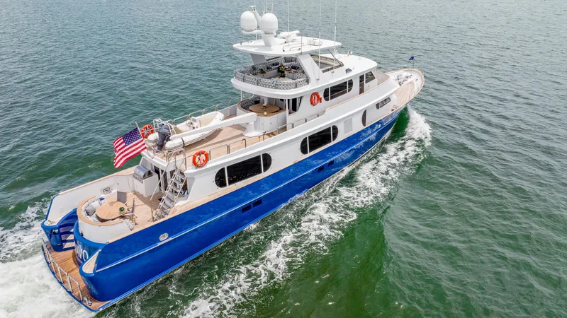 Slide: The Image of 1975 Stephens Brothers Expedition yacht cruising on open water, featuring a sleek blue and white design. - 4