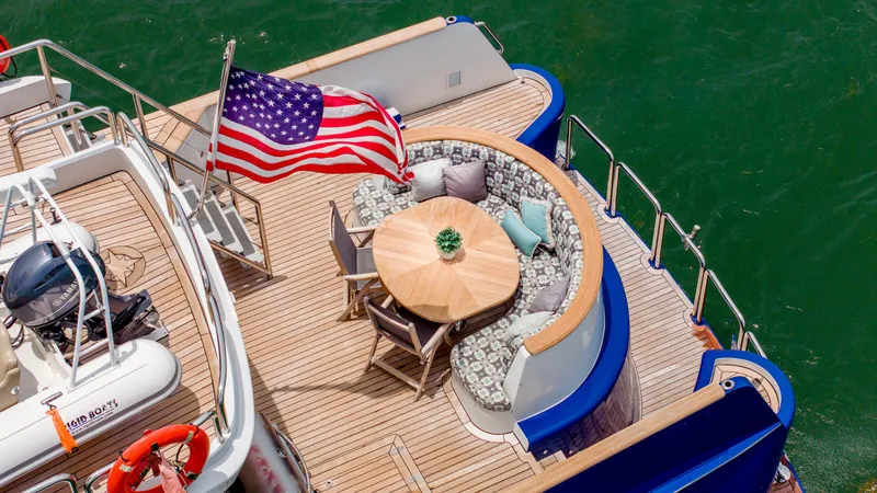 Slide: The Image of 1975 Stephens Brothers Expedition yacht deck with American flag and seating area. - 40