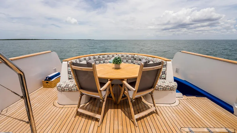 Slide: The Image of Deck of 1975 Stephens Brothers Expedition yacht with wooden table and ocean view. - 46