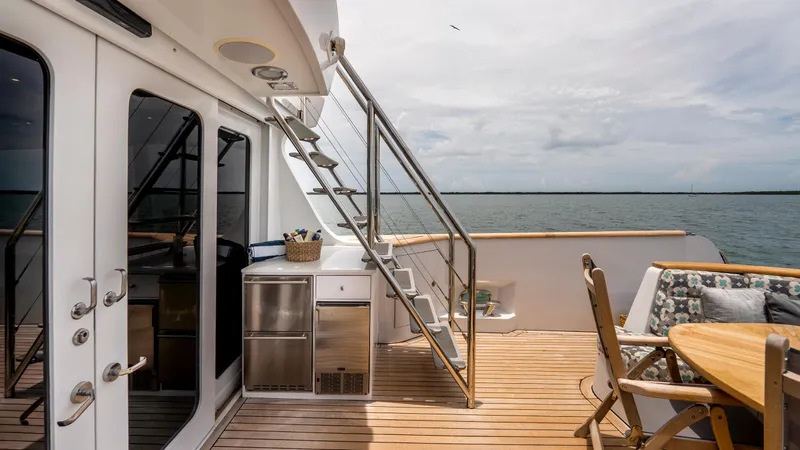 Slide: The Image of 1975 Stephens Brothers Expedition yacht deck with seating, stairs, and ocean view. - 48