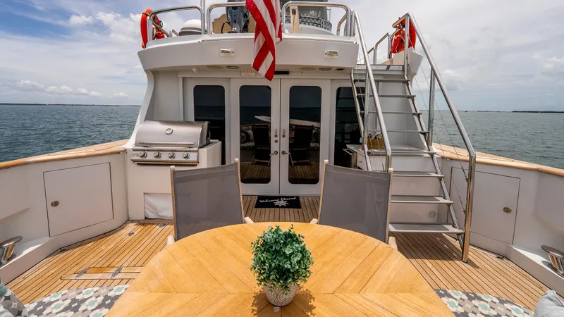 Slide: The Image of 1975 Stephens Brothers Expedition yacht deck with dining area, grill, and ocean view. - 49