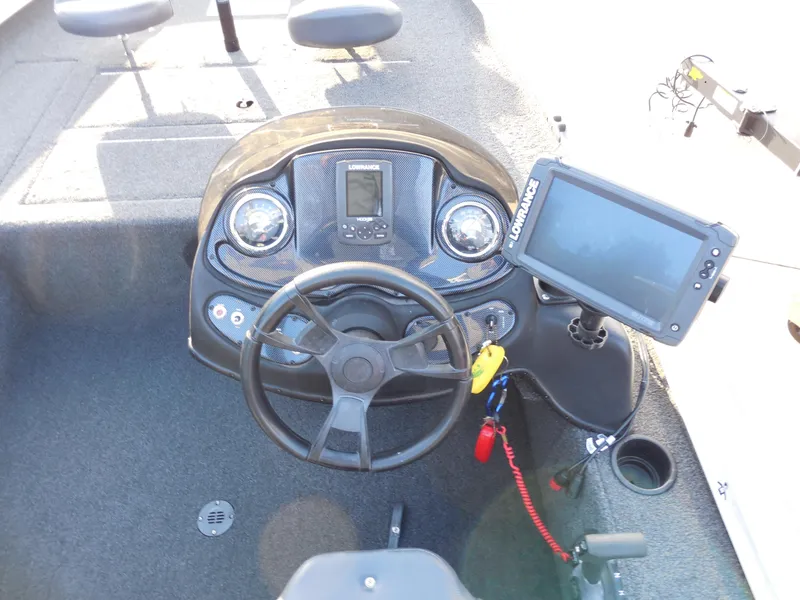 Slide: The Image of 2017 Lowe Stinger 175 boat dashboard with steering wheel and electronic display. - 11