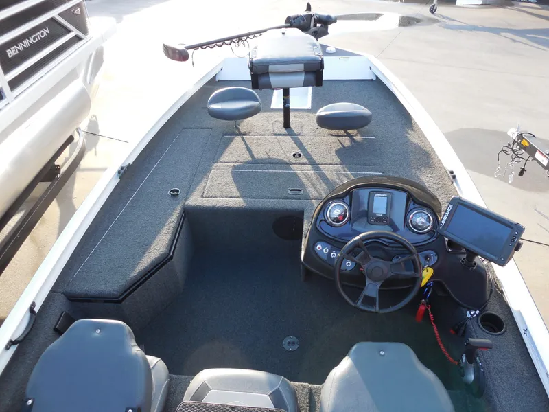 Slide: The Image of 2017 Lowe Stinger 175 boat interior with steering console and seating. - 12