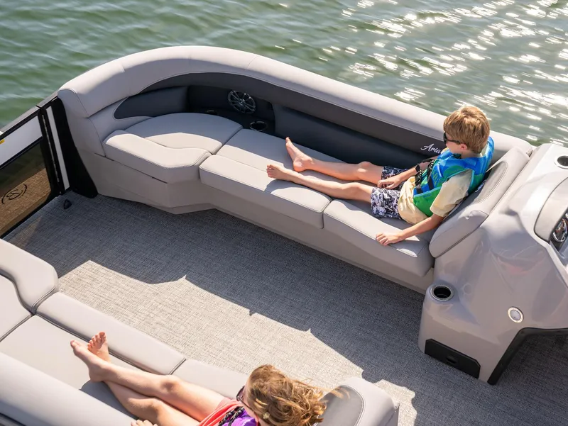 Slide: The Image of 2025 Barletta Aria 24UC pontoon boat with children relaxing on comfortable seating. - 10