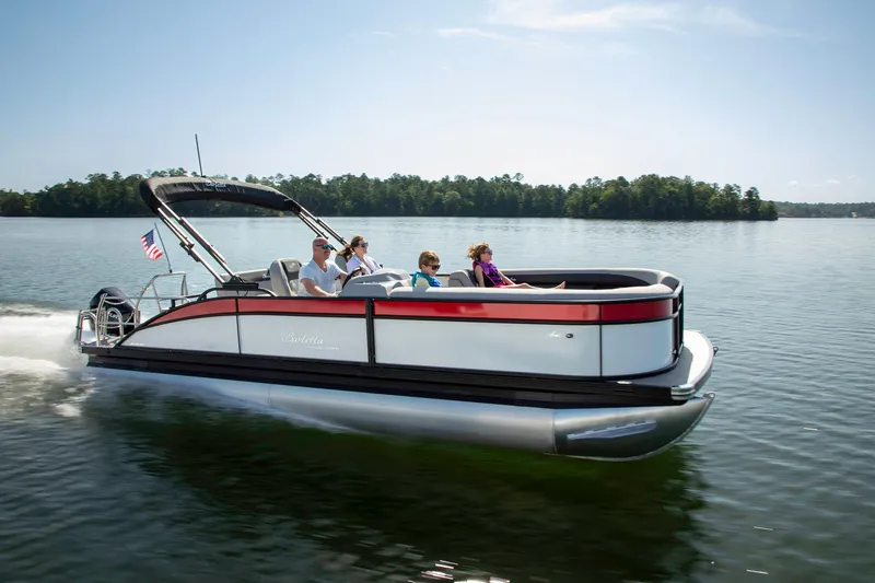 Slide: The Image of 2025 Barletta Aria 24UC pontoon boat cruising on a serene lake. - 3